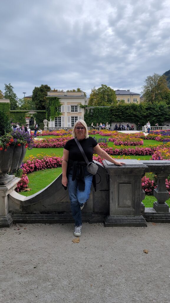 A photo of me in a floral garden in Salzburg Austria.