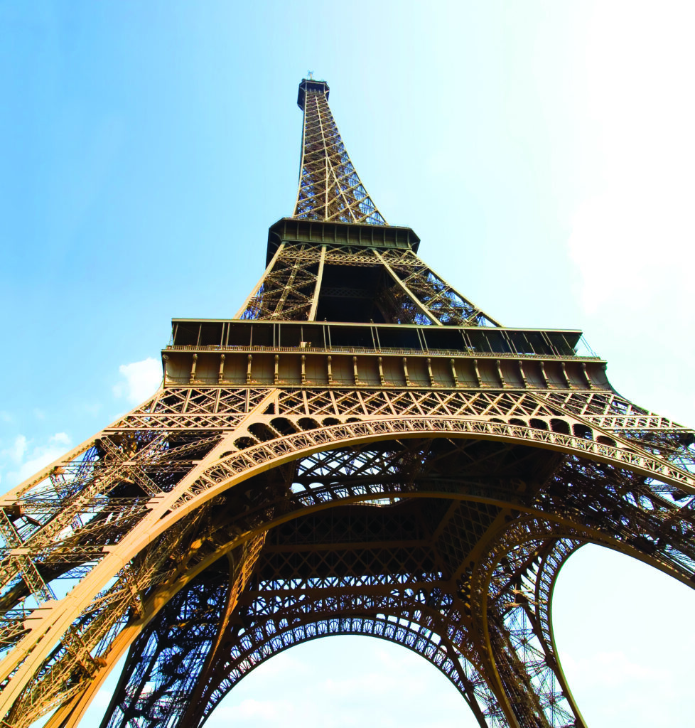 A photo of the Eiffel Tower taken from the bottom upwards.