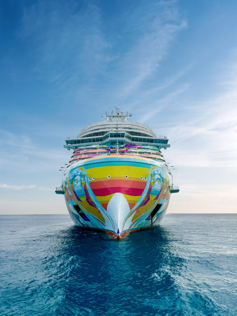 A photo taken from the front of a colorful cruise ship.